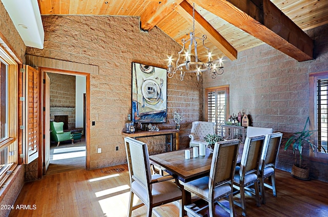 unfurnished dining area with wooden ceiling, vaulted ceiling with beams, wood-type flooring, and a notable chandelier