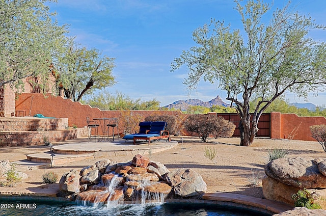 view of yard featuring a mountain view and a patio