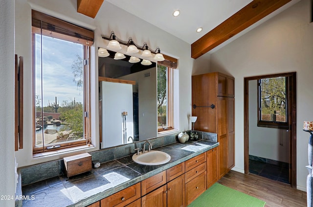 bathroom with lofted ceiling with beams, vanity, and wood-type flooring