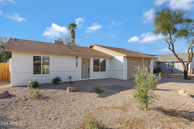 ranch-style house featuring a garage