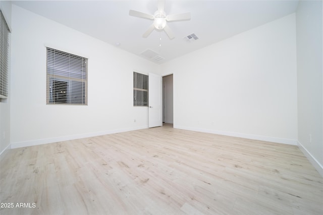 spare room featuring ceiling fan and light wood-type flooring