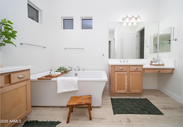 bathroom featuring hardwood / wood-style floors, vanity, and independent shower and bath