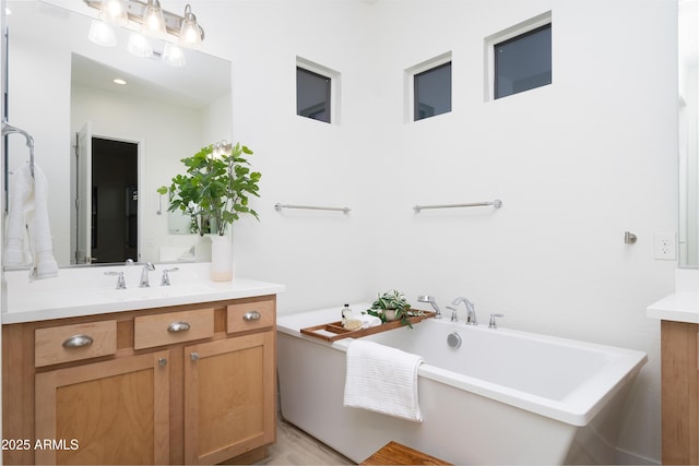 bathroom with vanity and a tub