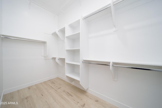 spacious closet with light hardwood / wood-style floors