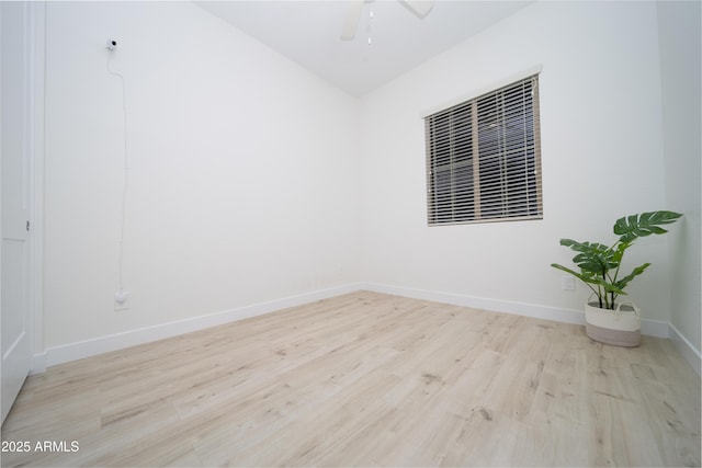 empty room with ceiling fan and light hardwood / wood-style flooring