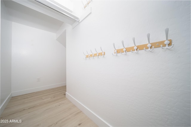 hallway with light hardwood / wood-style floors