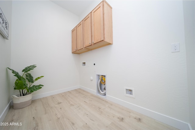 laundry room with electric dryer hookup, cabinets, hookup for a gas dryer, washer hookup, and light hardwood / wood-style floors