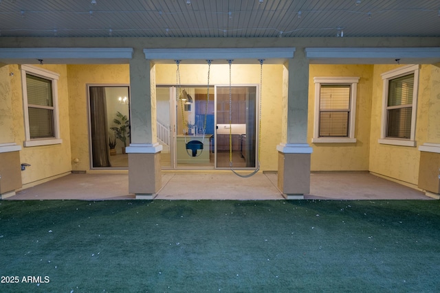 doorway to property featuring a yard and a patio area