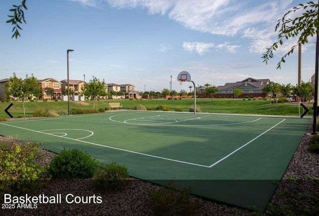 view of basketball court with a lawn