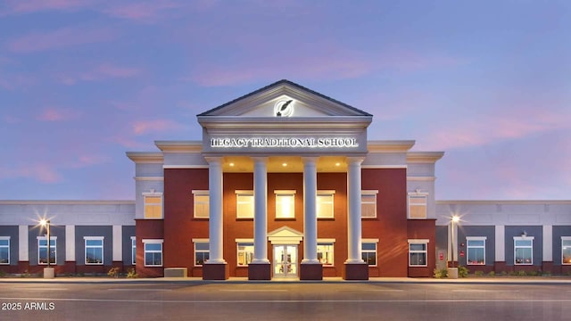 view of outdoor building at dusk