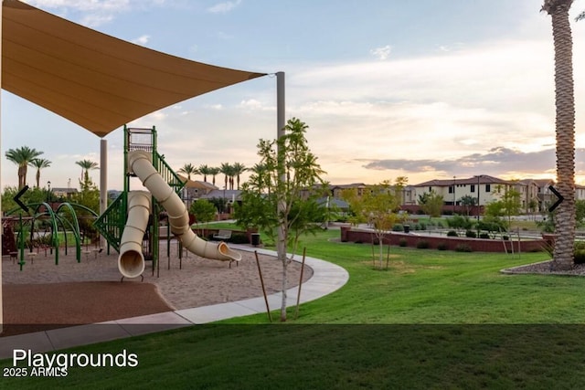 playground at dusk featuring a yard