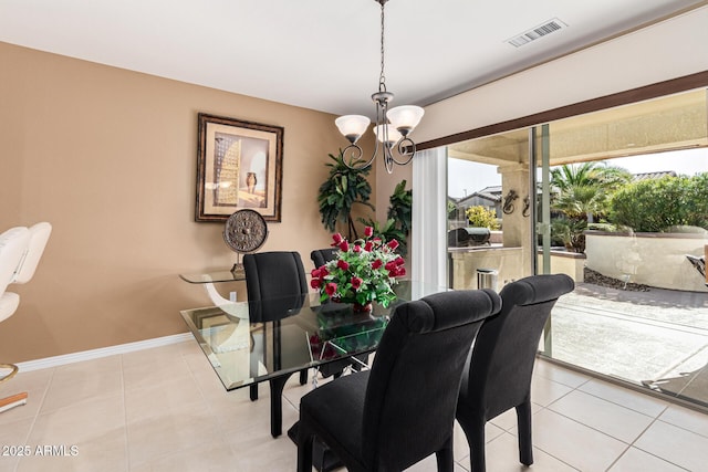 tiled dining room featuring an inviting chandelier and a healthy amount of sunlight