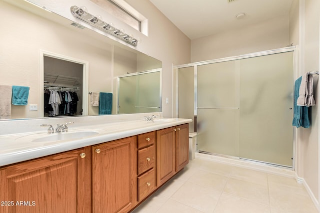 bathroom with vanity, an enclosed shower, and tile patterned floors