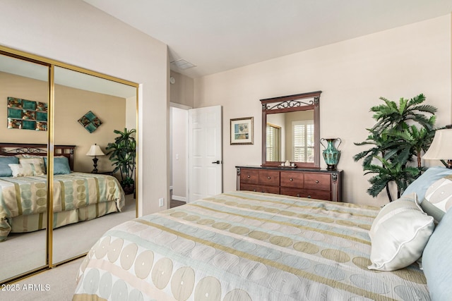 bedroom featuring light carpet and a closet