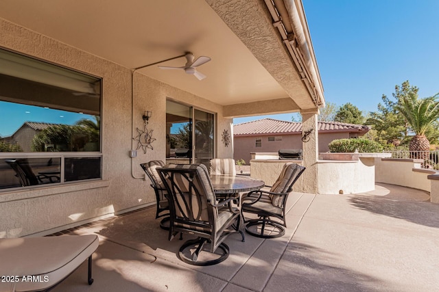 view of patio featuring ceiling fan and exterior kitchen