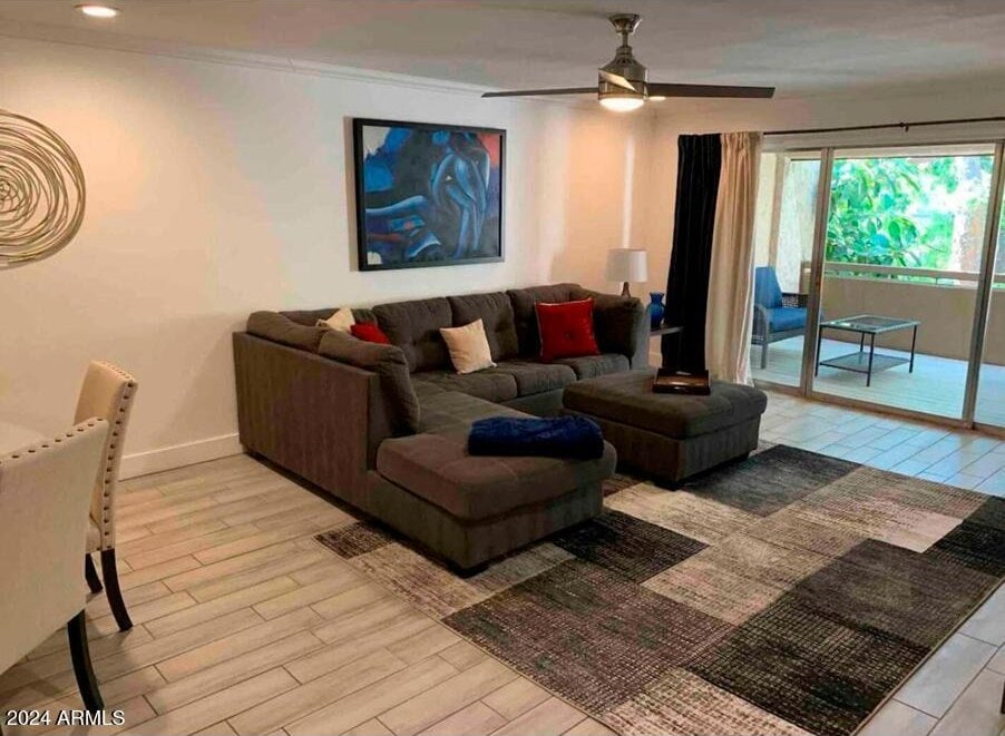 living room featuring light wood-type flooring and ceiling fan