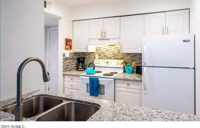 kitchen featuring white cabinetry, sink, light stone countertops, backsplash, and white appliances