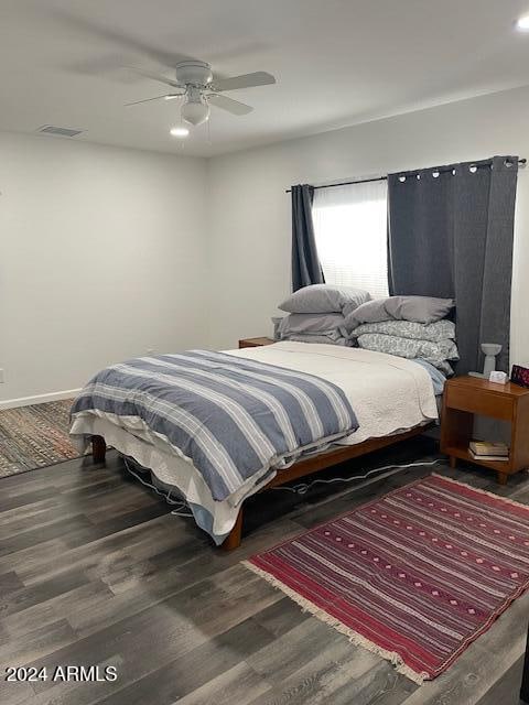 bedroom featuring dark wood-type flooring and ceiling fan