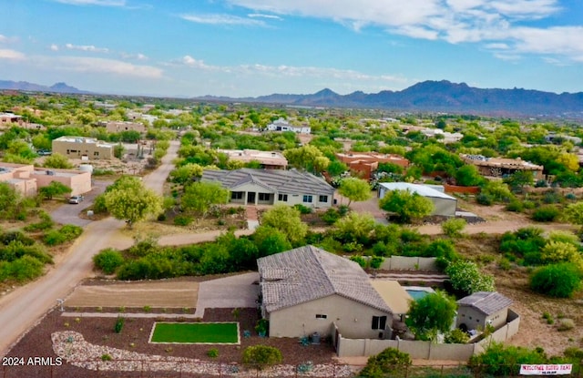 birds eye view of property with a mountain view