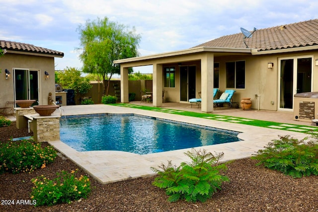 view of swimming pool with a patio area