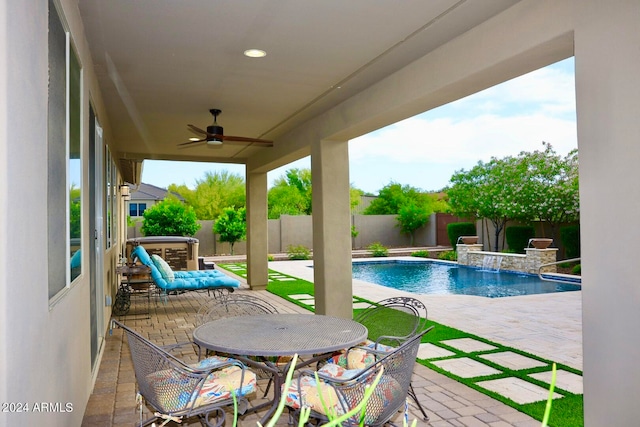 view of swimming pool with ceiling fan and a patio area