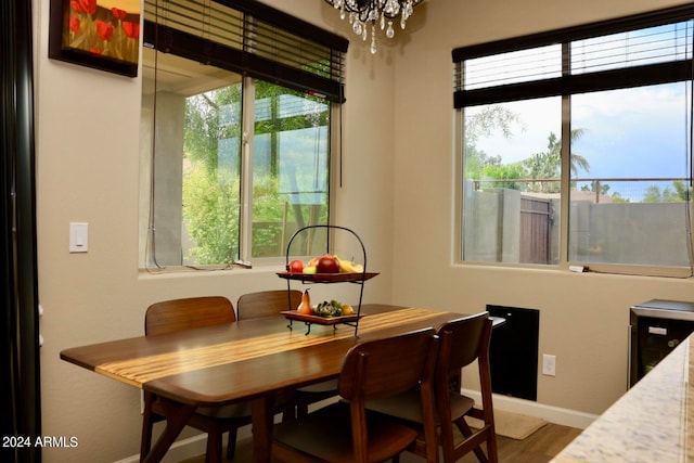 dining room with a wealth of natural light, a notable chandelier, and hardwood / wood-style flooring