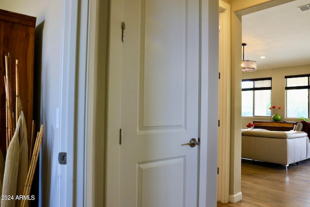 corridor with light hardwood / wood-style flooring