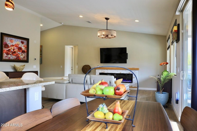 dining area with dark hardwood / wood-style flooring and lofted ceiling