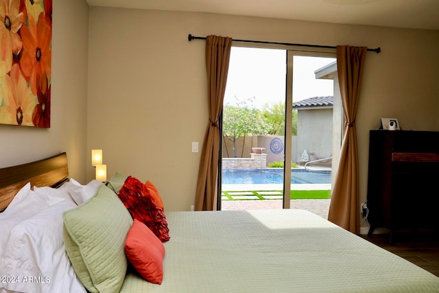 bedroom with access to exterior and dark wood-type flooring