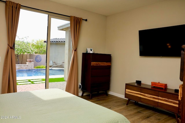 bedroom with dark wood-type flooring and access to exterior