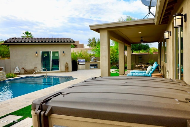 view of pool with a patio area, an outdoor kitchen, and grilling area