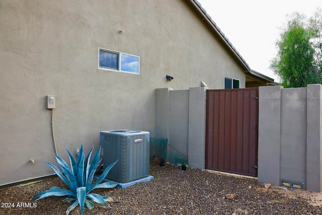 view of side of property with central air condition unit