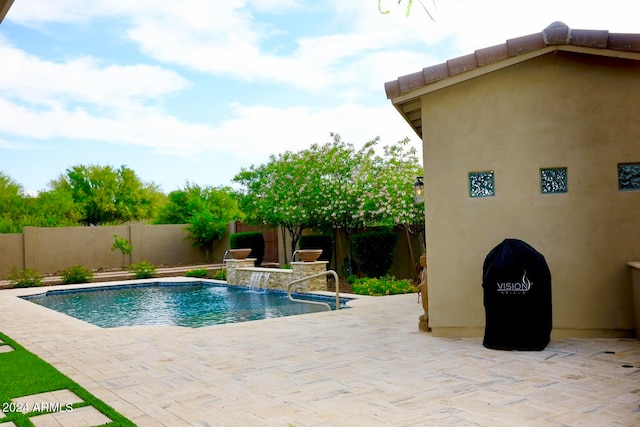 view of pool with a patio and pool water feature