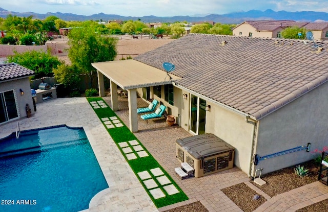 view of swimming pool featuring a patio and a mountain view