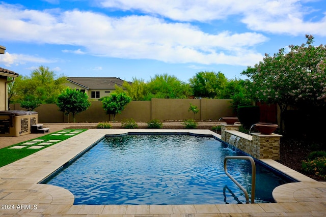 view of pool with a patio and pool water feature