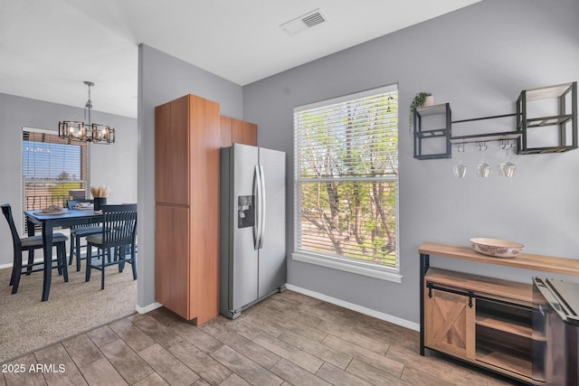 14250 W Wigwam Blvd Unit 2722, Litchfield Park, AZ 85340 - kitchen featuring stainless steel refrigerator with ice dispenser, a chandelier, wood tiled floors, and plenty of natural light