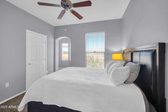 14250 W Wigwam Blvd Unit 2722, Litchfield Park, AZ 85340 - bedroom featuring carpet floors, arched walkways, baseboards, and a ceiling fan