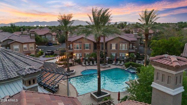 14250 W Wigwam Blvd Unit 2722, Litchfield Park, AZ 85340 - view of swimming pool featuring a pool with connected hot tub, a patio area, a residential view, and a mountain view