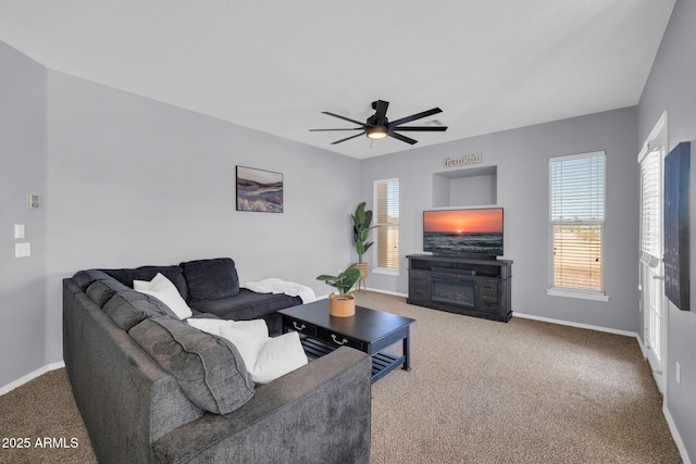 14250 W Wigwam Blvd Unit 2722, Litchfield Park, AZ 85340 - living area featuring carpet, plenty of natural light, a glass covered fireplace, and baseboards