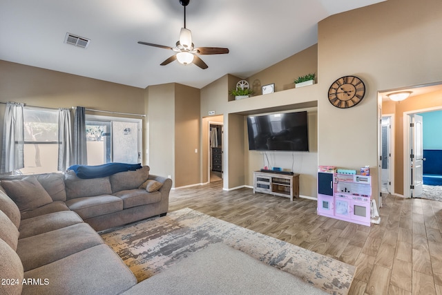 living room with high vaulted ceiling, light wood-type flooring, and ceiling fan