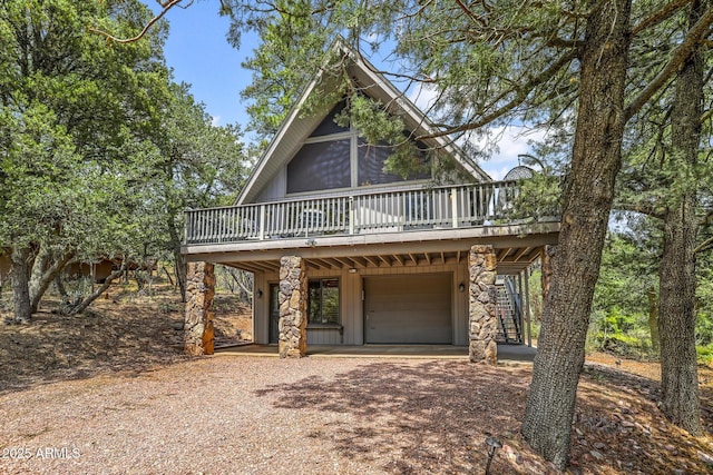 view of front facade with a wooden deck and a garage