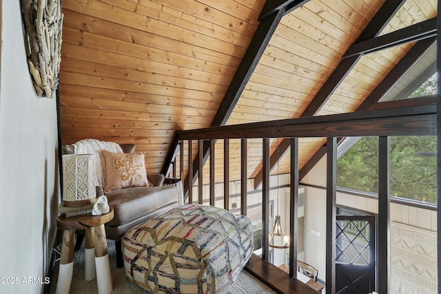 unfurnished room featuring a healthy amount of sunlight, wooden walls, lofted ceiling with beams, and wooden ceiling