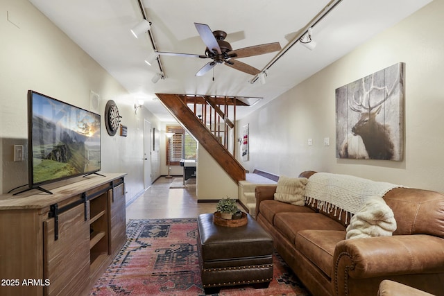 living room with hardwood / wood-style flooring, track lighting, and ceiling fan