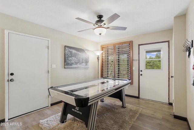 game room with ceiling fan and light wood-type flooring