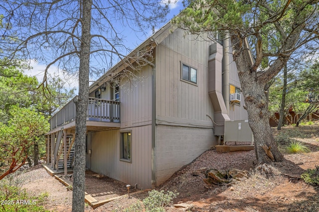 view of side of property with cooling unit and a deck