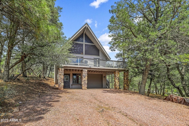 view of front of property with a wooden deck and a garage