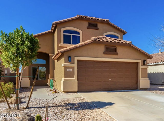 mediterranean / spanish-style house with a garage