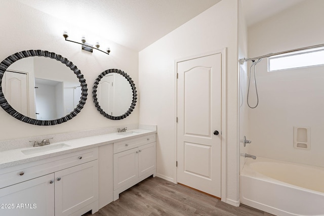 bathroom featuring lofted ceiling, vanity, bathing tub / shower combination, and hardwood / wood-style floors