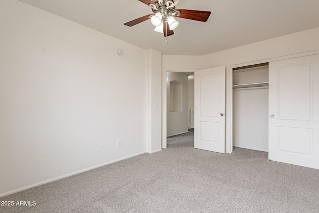 unfurnished bedroom with ceiling fan, carpet floors, and a closet