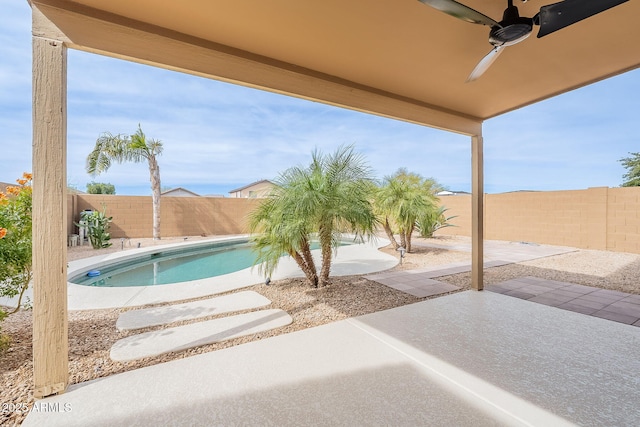 view of patio / terrace with a fenced in pool and ceiling fan